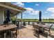An outdoor seating area with views of a tranquil pond at 18172 Ramble On Way, Land O Lakes, FL 34638