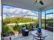 Comfortable screened-in patio with outdoor seating and a view of the green backyard at 18172 Ramble On Way, Land O Lakes, FL 34638