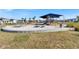 Community playground with a large play structure, shade covering, picnic tables and ample seating at 18172 Ramble On Way, Land O Lakes, FL 34638