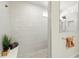 Modern shower featuring tiled walls, a shower head, and a window at 18172 Ramble On Way, Land O Lakes, FL 34638