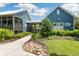 Charming swim club with game room, featuring blue siding, lush landscaping, and a welcoming entrance at 18172 Ramble On Way, Land O Lakes, FL 34638