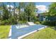 An outdoor exercise park with blue flooring and various fitness stations surrounded by trees at 18172 Ramble On Way, Land O Lakes, FL 34638