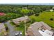 Aerial view of townhomes surrounded by lush greenery and mature trees providing a tranquil setting at 1883 Clearbrooke Dr, Clearwater, FL 33760