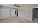 Spacious bedroom featuring neutral tones, carpeted floors, a ceiling fan, and closet space at 1883 Clearbrooke Dr, Clearwater, FL 33760