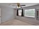 Bedroom with neutral carpet, ceiling fan, and natural light from two windows at 1883 Clearbrooke Dr, Clearwater, FL 33760