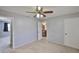 Bedroom featuring carpeted floors, ceiling fan, and access to an ensuite bathroom at 1883 Clearbrooke Dr, Clearwater, FL 33760