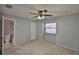 Bedroom with carpeted floors, window with blinds, ceiling fan, and an ensuite bathroom at 1883 Clearbrooke Dr, Clearwater, FL 33760