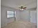 Bedroom featuring a window with blinds, ceiling fan, and a neutral color scheme at 1883 Clearbrooke Dr, Clearwater, FL 33760