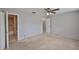 Neutral bedroom boasting carpeted floors, ceiling fan and ensuite bathroom at 1883 Clearbrooke Dr, Clearwater, FL 33760