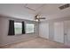 Bedroom with two windows, a ceiling fan and two white double closets at 1883 Clearbrooke Dr, Clearwater, FL 33760