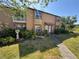 Charming two-story condo with a welcoming walkway and a well-maintained lawn and tropical landscaping at 1883 Clearbrooke Dr, Clearwater, FL 33760