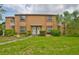 Inviting two-story townhome featuring a well-kept lawn and tidy landscaping, offering great curb appeal at 1883 Clearbrooke Dr, Clearwater, FL 33760