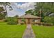 Charming exterior view of home with well-manicured lawn and lush landscaping at 1883 Clearbrooke Dr, Clearwater, FL 33760