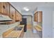 Kitchen with wooden cabinets, white appliances and tile flooring at 1883 Clearbrooke Dr, Clearwater, FL 33760