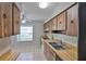 Bright kitchen with wood cabinets, a white oven, double sink, and tiled backsplash at 1883 Clearbrooke Dr, Clearwater, FL 33760