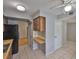 Open kitchen view into a doorway and features tiled floors and wood cabinets at 1883 Clearbrooke Dr, Clearwater, FL 33760