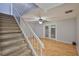 Bright living room featuring wood flooring and a staircase, illuminated by a ceiling fan at 1883 Clearbrooke Dr, Clearwater, FL 33760