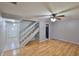 Spacious living area features wood flooring, stairway, fan, and easy access to other rooms at 1883 Clearbrooke Dr, Clearwater, FL 33760