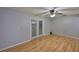 Open living area features sleek wood flooring, fan, and double doors for a bright, airy feel at 1883 Clearbrooke Dr, Clearwater, FL 33760