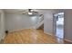 Open-concept living area featuring wood flooring, fan, and stair access; perfect for modern living at 1883 Clearbrooke Dr, Clearwater, FL 33760