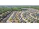 Scenic aerial view of a residential development with tree-lined streets, inviting ponds, and cozy homes at 19032 Malinche Loop, Spring Hill, FL 34610