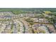 Neighborhood aerial view displays charming homes near a tranquil pond and a community recreation area at 19032 Malinche Loop, Spring Hill, FL 34610