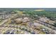 Aerial view showcases a suburban neighborhood and a nearby pond surrounded by lush greenery at 19032 Malinche Loop, Spring Hill, FL 34610
