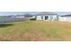 Fenced backyard with green grass and a patio, providing a private outdoor living space at 19032 Malinche Loop, Spring Hill, FL 34610