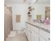 Bathroom featuring a double vanity, granite countertop, and shower-tub combo at 19032 Malinche Loop, Spring Hill, FL 34610