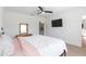 A stylish bedroom with a ceiling fan, carpet, TV, and ensuite bathroom at 19032 Malinche Loop, Spring Hill, FL 34610