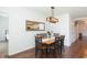 Dining room features a table for six and a mirror reflecting the bright, white kitchen at 19032 Malinche Loop, Spring Hill, FL 34610