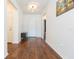 Inviting foyer with gleaming hardwood floors, modern light fixture, and neutral wall paint at 19032 Malinche Loop, Spring Hill, FL 34610