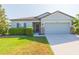 Charming single-story home with manicured lawn, a two-car garage and stone-accented entry at 19032 Malinche Loop, Spring Hill, FL 34610