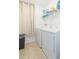 Bright laundry room featuring a washer, dryer, tile floor, and shelving at 19032 Malinche Loop, Spring Hill, FL 34610