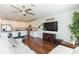 Open-concept living space features a modern kitchen, stainless steel appliances, and spacious seating area at 19032 Malinche Loop, Spring Hill, FL 34610