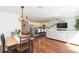 An open-concept space flows from the dining area to the kitchen and living room with hardwood floors at 19032 Malinche Loop, Spring Hill, FL 34610