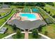 A beautiful aerial view of a community pool, playground, and multiple sporting courts on a sunny day at 19032 Malinche Loop, Spring Hill, FL 34610