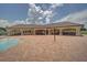 A wide angle of the veranda at the community pool, with brick pavers and support columns at 19032 Malinche Loop, Spring Hill, FL 34610