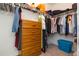 Walk-in closet with shelving, closet rods, and wooden dresser at 19032 Malinche Loop, Spring Hill, FL 34610