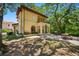Beautiful backyard with a brick patio, outdoor dining space, and a balcony overlooking the lush greenery at 1966 Freedom Dr, Clearwater, FL 33755