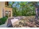 Expansive backyard featuring a brick patio, outdoor dining set, and mature trees providing ample shade at 1966 Freedom Dr, Clearwater, FL 33755
