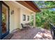 Spacious outdoor balcony with an iron railing, a table and chairs, and lush views of the trees at 1966 Freedom Dr, Clearwater, FL 33755