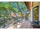 Balcony with tile floor and iron railings overlooking trees and other buildings at 1966 Freedom Dr, Clearwater, FL 33755