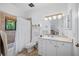 Well-lit bathroom with a shower/tub combo and vanity with sink at 1966 Freedom Dr, Clearwater, FL 33755