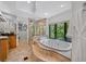 Gorgeous bathroom with a jacuzzi tub, walk-in shower, custom cabinets, and large windows at 1966 Freedom Dr, Clearwater, FL 33755