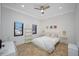 Bright bedroom with two windows, tile flooring, neutral decor, and a ceiling fan at 1966 Freedom Dr, Clearwater, FL 33755