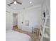 Bright bedroom featuring neutral decor, a ceiling fan, tile flooring and closet for ample storage at 1966 Freedom Dr, Clearwater, FL 33755