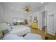 Light-filled bedroom with tile floors, a ceiling fan, and serene views of the outdoor scenery at 1966 Freedom Dr, Clearwater, FL 33755