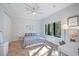 Bright, spacious bedroom featuring neutral decor, ceiling fan, and a large window at 1966 Freedom Dr, Clearwater, FL 33755