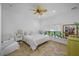 Bright bedroom with large windows, neutral decor, ceiling fan, and tile floors at 1966 Freedom Dr, Clearwater, FL 33755